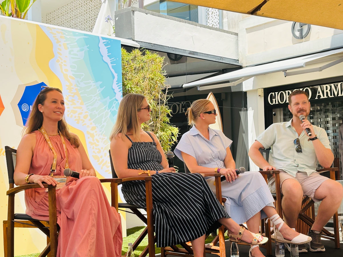 AdQuick speaking on a panel at Brand Innovators in Cannes, four panelists seated outdoors with microphones.